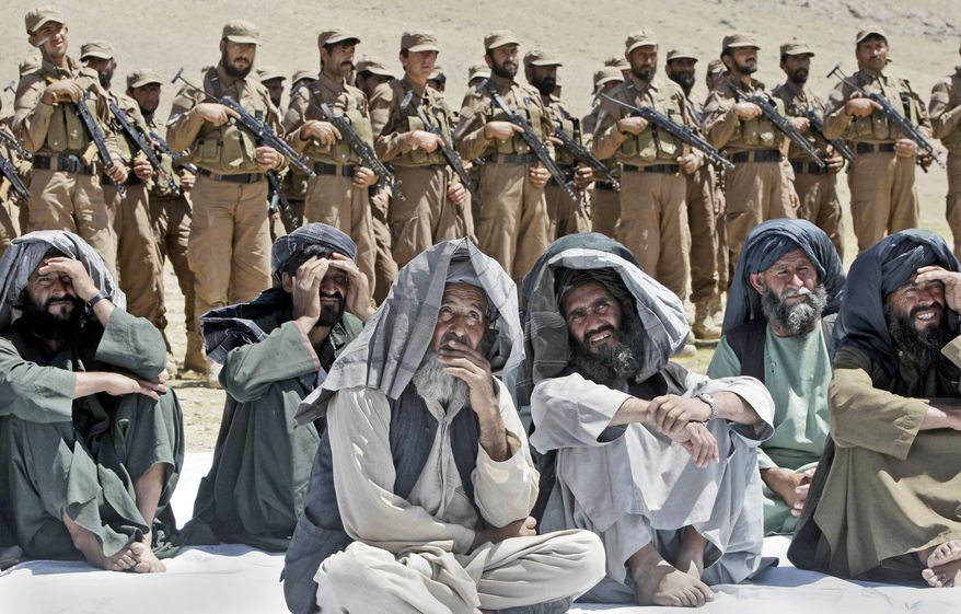 Villagers join Afghan Local Police on Thursday, March 29, 2012, for a ceremony in Gizab at which new uniforms were presented. Commanders think the units are capable of holding villages after NATO troops clear out the enemy. (Associated Press)