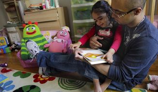 ** FILE ** Christopher Astacio reads with his daughter Cristina, 2, who recently was diagnosed with a mild form of autism, in her bedroom on Wednesday, March 28, 2012, in New York. Autism cases are on the rise again, largely because of wider screening and better diagnosis, federal health officials say. (AP Photo/Bebeto Matthews)