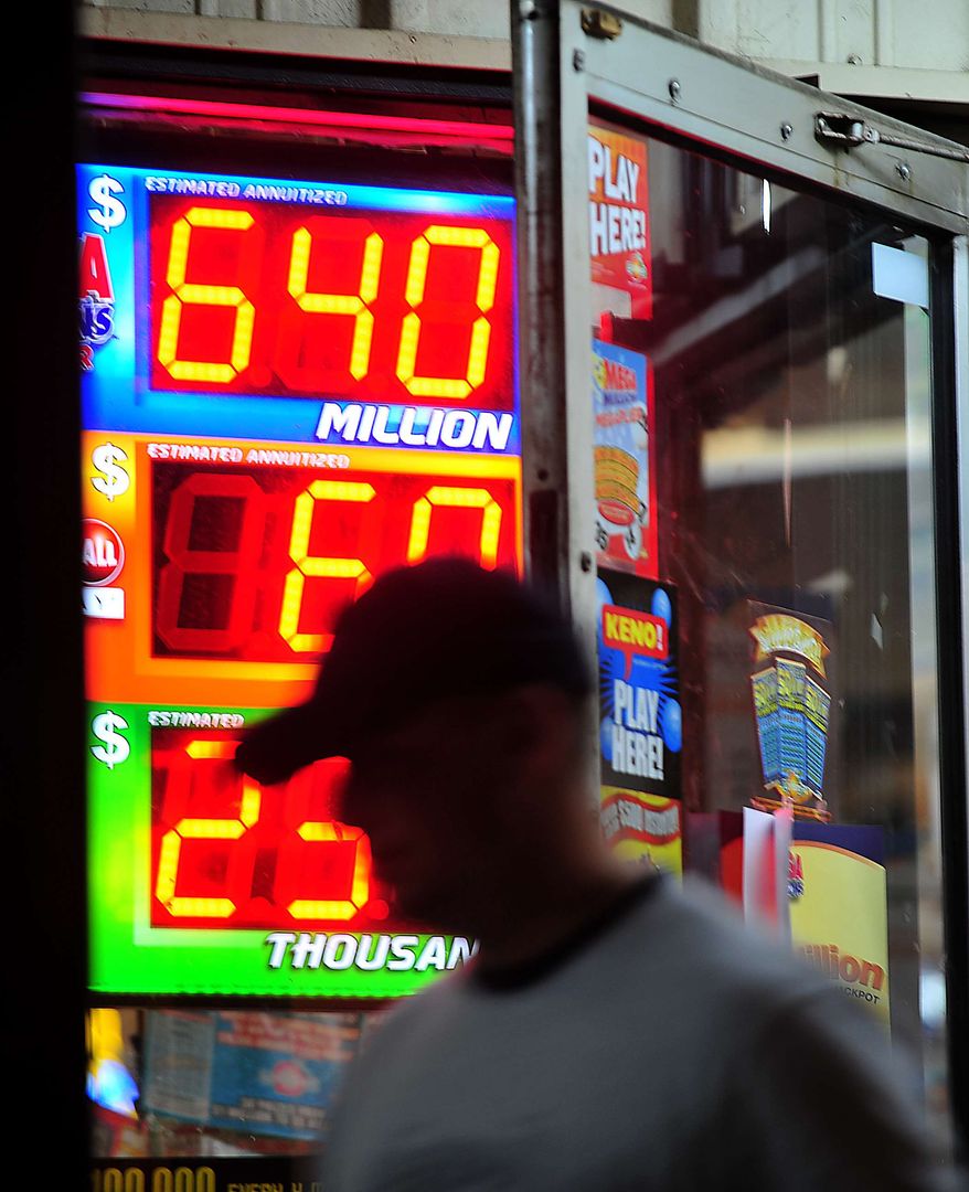 A customer walks out of the Riverside Travel Center in Hilton, Ga., late Friday night after purchasing a lottery ticket for the Mega Millions Lottery, which reached an estimated jackpot of $645 million for Friday night's drawing. (AP Photo/Jay Hare, The Eagle)