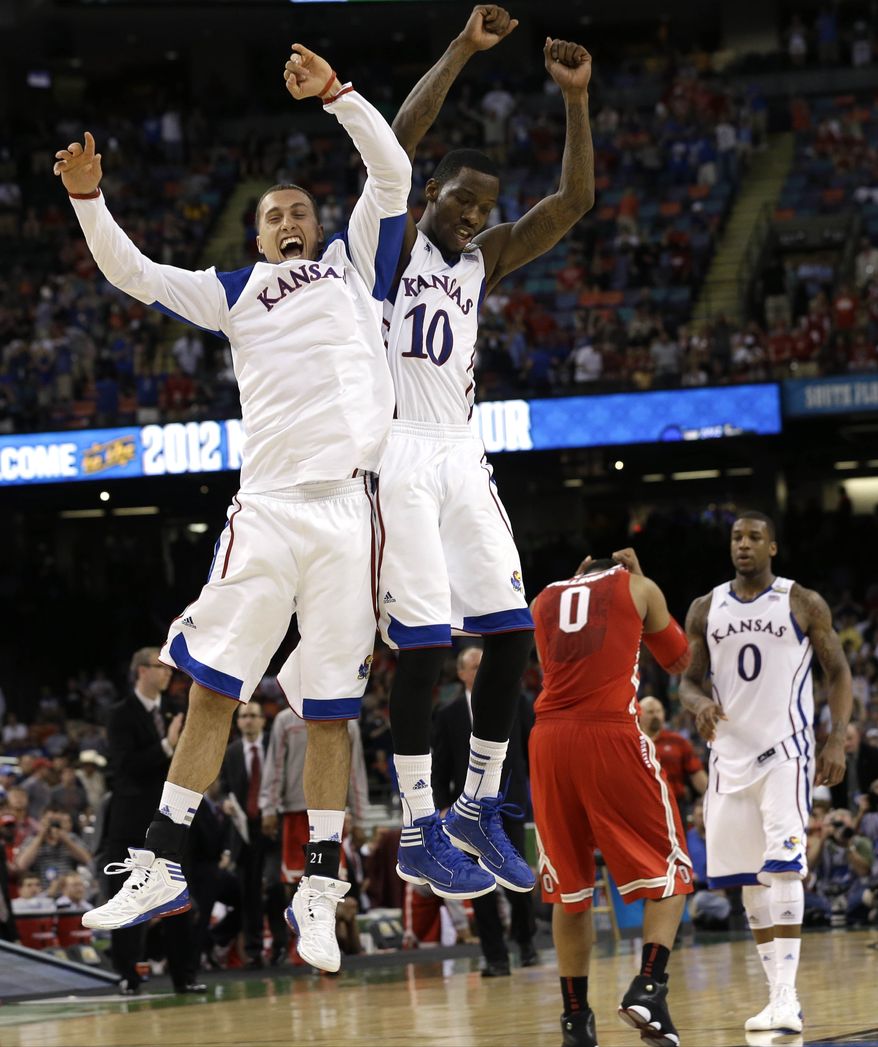 Kansas guard Tyshawn Taylor (10) celebrates with Kansas guard Christian Garrett at the end of an NCAA Final Four tournament game against Ohio State Saturday, March 31, 2012, in New Orleans. Kansas won 64-62 to advance to the national title game versus Kentucky. (AP Photo/David J. Phillip)