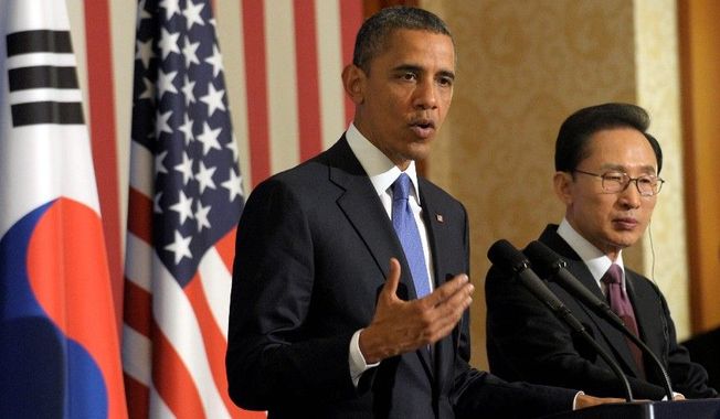 President Obama talks of reunification with North Korea during his visit to South Korea. President Lee Myung-bak is on hand. (Associated Press)