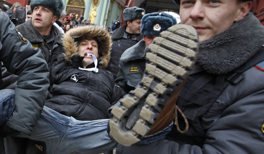 Russian police detain a protester during an unsanctioned rally against Prime Minister Valdimir Putin, the president-elect, in Moscow on Sunday, April 1, 2012. (AP Photo/Mikhail Metzel)