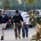 **FILE** Immigration and Customs Enforcement (ICE) agents take a suspect into custody as part of a nationwide immigration sweep in Chula Vista, Calif., on March 30, 2012. (Associated Press)