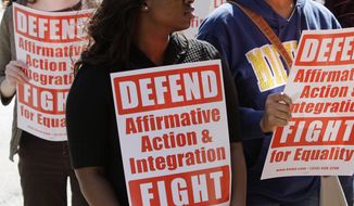 **FILE** Students demonstrate outside the Federal Courthouse on March 7, 2012, in Cincinnati, where the Sixth Circuit Court of Appeals was hearing oral arguments in their review of their 2011 ruling that Proposal 2, the ban on affirmative action in Michigan, is unconstitutional. (Associated Press)