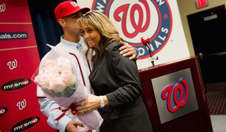 Gio Gonzalez gave a bouquet and a kiss to his mother, Yolanda Cid-Gonzalez, when he was introduced as a member of the Washington Nationals in January. (Andrew Harnik/The Washington Times)