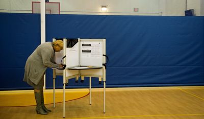D.C. Council member Yvette Alexander, Ward 7 Democrat, casts her vote at the Randle-Highlands Elementary School precinct in Southeast on Tuesday. (Rod Lamkey Jr./The Washington Times)