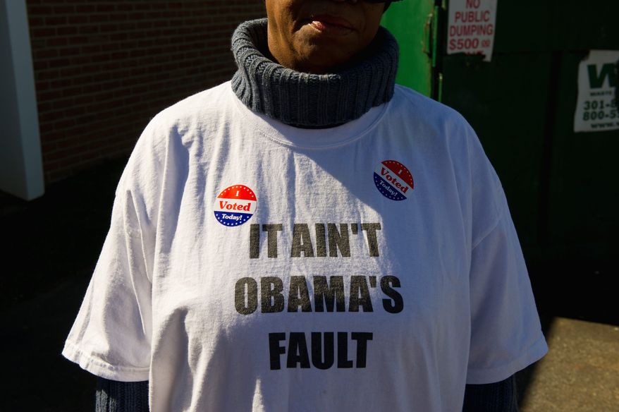 Ward 8 resident Teresa Stuart wears her views on a T-shirt after casting her vote at New Image Baptist on Tuesday. (Andrew Harnik/The Washington Times)