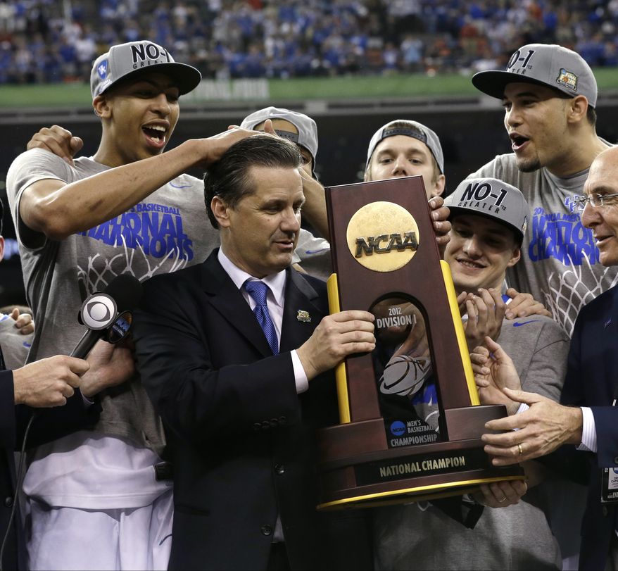 Kentucky head coach John Calipari, center, celebrates with his team after it won the NCAA championship game against Kansas on Monday, April 2, 2012, in New Orleans. Kentucky won 67-59. (AP Photo/David J. Phillip)