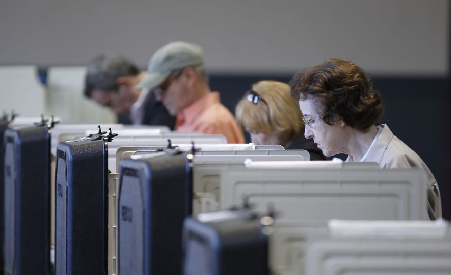 Voters cast their ballot at a polling place during a primary election in Frederick, Md., Tuesday, April 3, 2012. (AP Photo/Luis M. Alvarez)