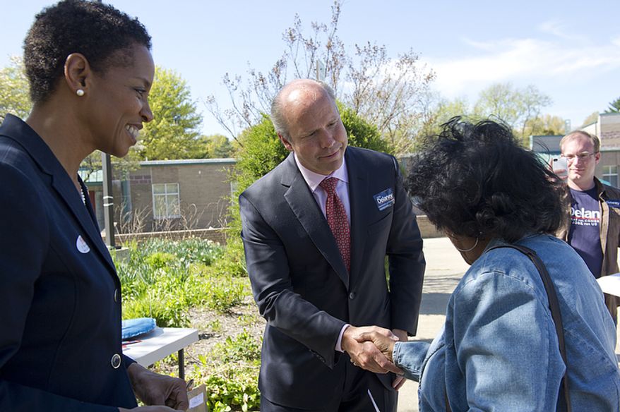 John Delaney (center), a Democratic candidate for Congress in Maryland, shakes hands with a voter outside of Flower Valley Elementary School in Rockville, Md., as Rep. Donna F. Edwards (left) watches on April 3, 2012, the day of Maryland's primary election. Delaney has been in a tight race with state Senate Majority Leader Robert J. Garagiola. (Barbara L. Salisbury/The Washington Times)