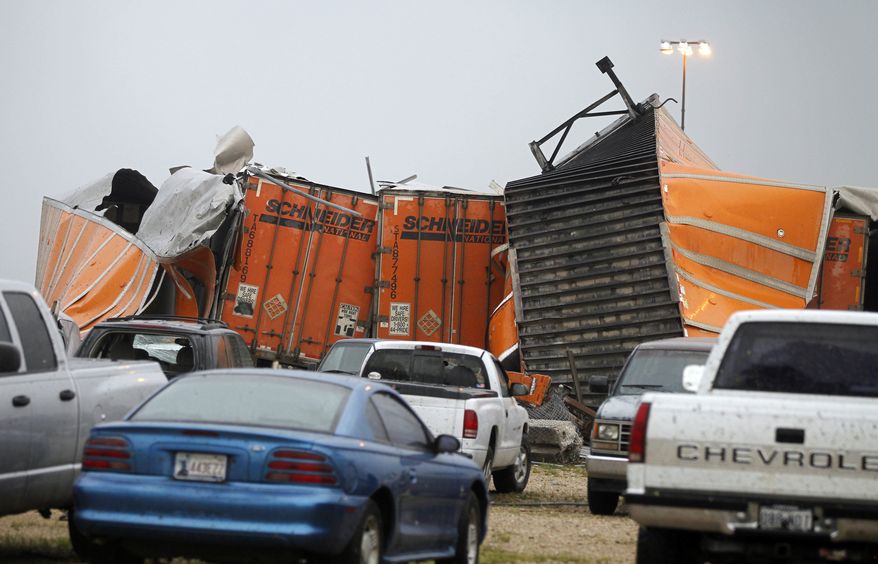 Trailers lay smashed atop one another after a tornado reportedly tore through the southeastern portion of Dallas County, Texas, Tuesday, April 3, 2012, near Lancaster, Texas. The National Weather Service confirmed at least two separate "large and extremely dangerous" tornadoes in the Dallas-Fort Worth area. (AP Photo/The Dallas Morning News, G.J. McCarthy)