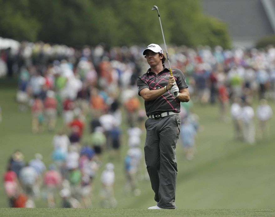 Rory McIlroy, of Northern Ireland, watches his shot from the first fairway during a practice round for the Masters golf tournament Tuesday, April 3, 2012, in Augusta, Ga. (AP Photo/Charlie Riedel)