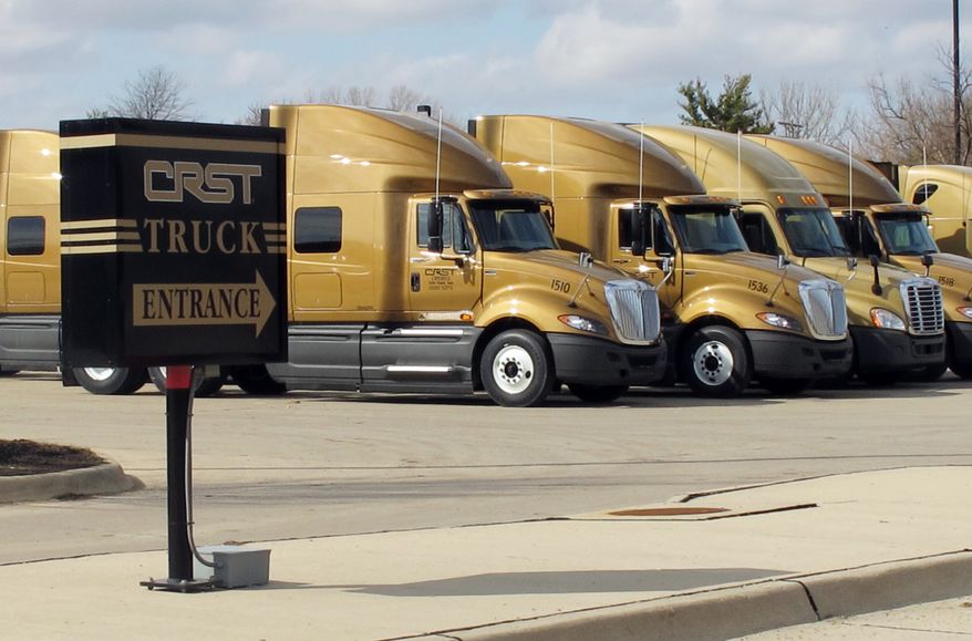 **FILE** Trucks sit outside the headquarters of CRST Van Expedited, Inc., in Cedar Rapids, Iowa, on March 12, 2012. (Associated Press)