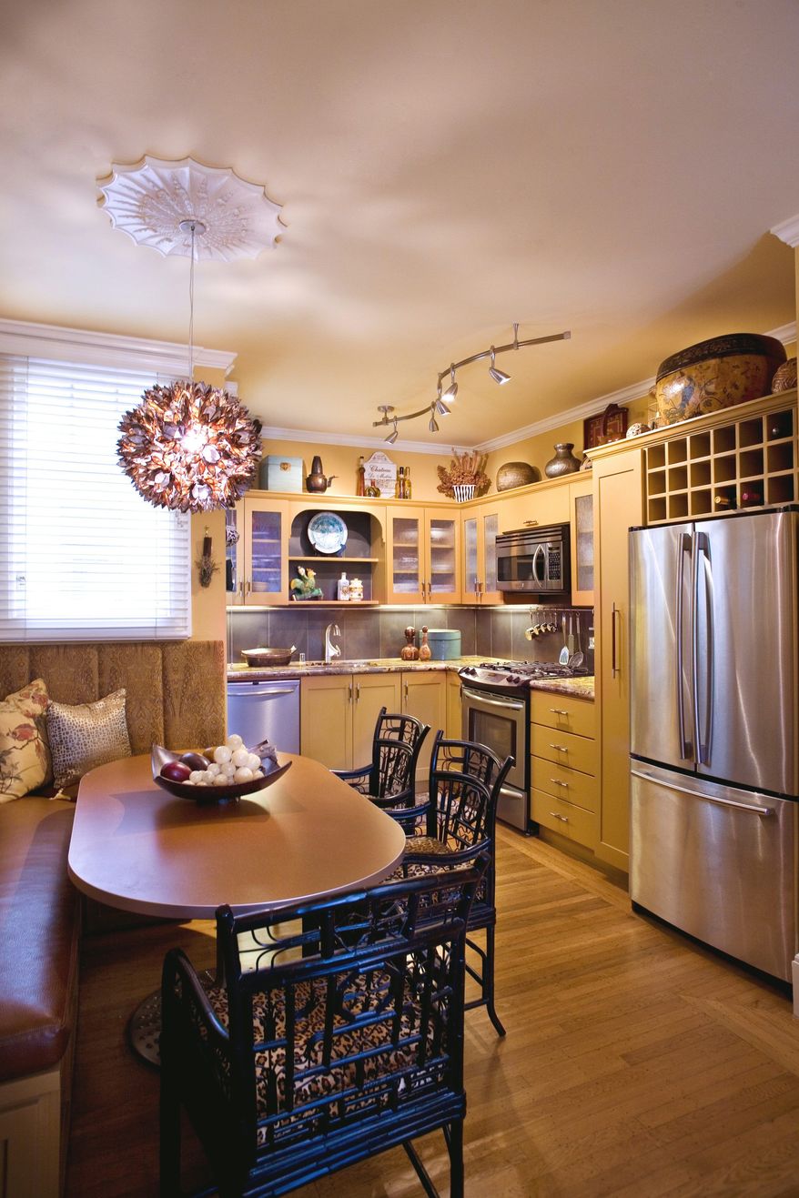 In this undated photo courtesy of the Adeeni Group, a ceiling makeover featuring a chandelier with ceiling medallion is shown. Design experts say there are plenty of easy ways to make over this oft-overlooked area, from the quirky charm of Victorian-era, pressed-tin tiles and beadboard to something as simple as a splash of color. (AP Photo/Adeeni Design Group)