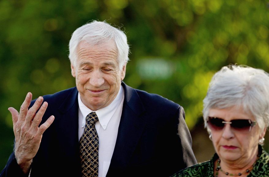 Jerry Sandusky, a former Penn State University assistant football coach charged with sexually abusing boys, is accompanied by wife Dottie as he arrives Thursday at the Centre County Courthouse in Bellefonte, Pa. (Associated Press)