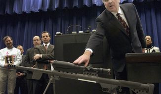 ** FILE ** Richard M. Daley, then the mayor of Chicago, points to a .50-caliber assault weapon during a news conference in 2005. (AP Photo/M. Spencer Green)