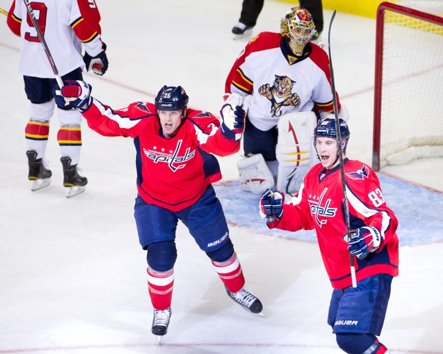 Washington Capitals left wing Matt Hendricks (26), second from left, celebrates as Washington Capitals center Jay Beagle (83), right, scores on Florida Panthers goalie Jose Theodore (60) to bring the Washington Capitals up 1-0 against the Florida Panthers in the first period during National Hockey League hockey at the Verizon Center, Washington, D.C., Thursday, April 5, 2012. (Andrew Harnik/The Washington Times)