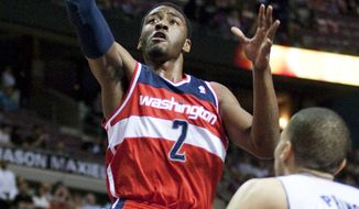 Washington Wizards&#39; John Wall goes to the basket against Detroit Pistons&#39; Tayshaun Prince in the first half of Thursday, April 5, 2012, in Auburn Hills, Mich. (AP Photo/Duane Burleson)

