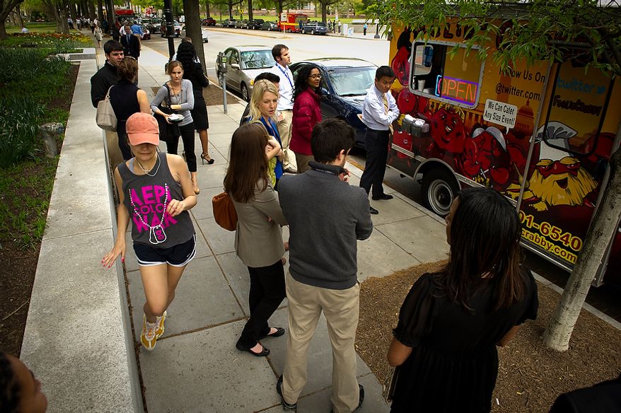 A constant line of people wait for the chance to order food at the Feelin' Crabby? food truck, parked near the corner of Virginia Avenue 20th Street NW and in Washington, D.C., Wednesday, April 4, 2012. (Rod Lamkey Jr/The Washington Times)