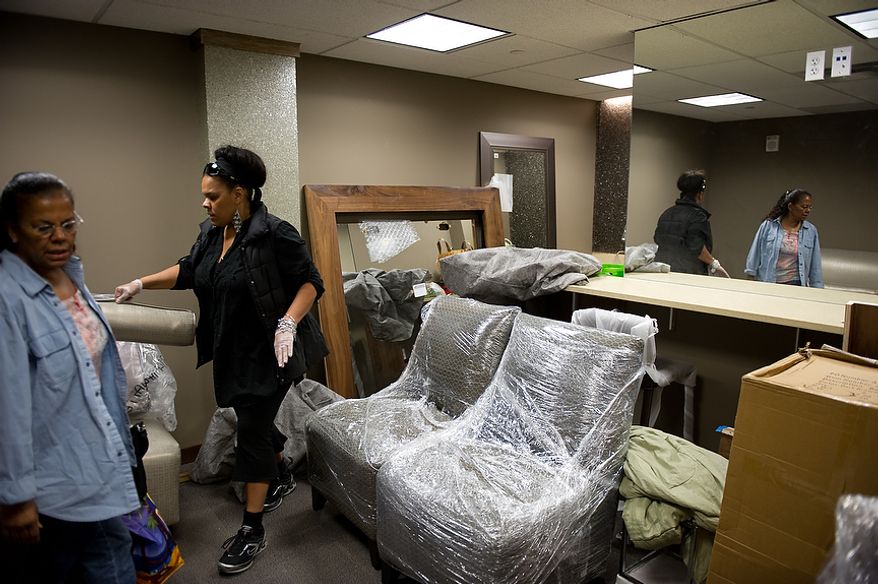 Sofalé Ellis, owner of Sofalé Artistic Designs, second from left, and her mother Phyllis Ellis of Glendale, Md., left, set up the downstairs green room of the redesigned historic Howard Theatre which is set to reopen with a ribbon cutting Monday and an opening night gala on Thursday, Washington, D.C., Thursday, April 5, 2012. (Andrew Harnik/The Washington Times)