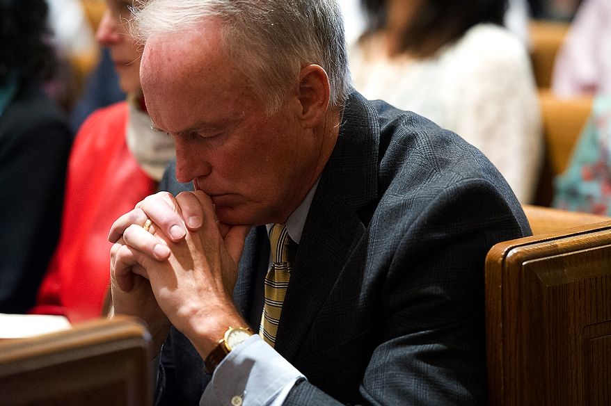 A man prays during the Homily at the Mass of the Lord's Supper at the Cathedral of St. Matthew the Apostle in Washington, D.C. on Holy Thursday, April 5, 2012. (Barbara L. Salisbury/The Washington Times)