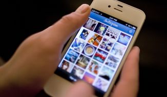 **FILE** Instagram is demonstrated on an iPhone on April 9, 2012, in New York. (Associated Press)
