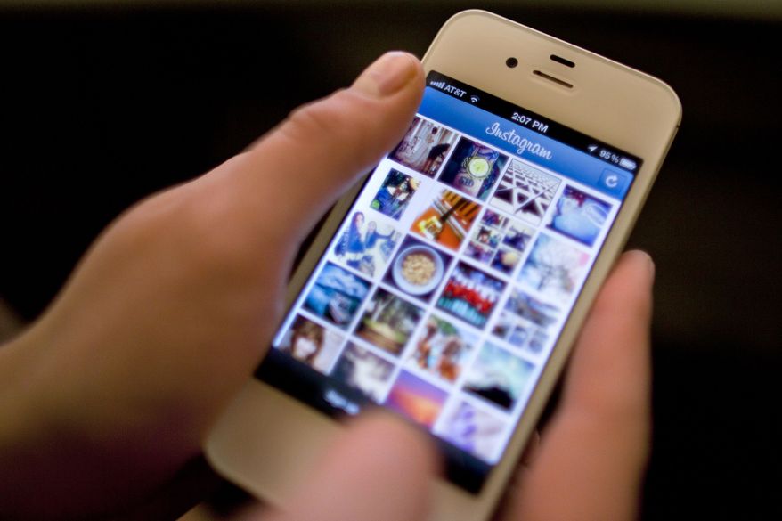 **FILE** Instagram is demonstrated on an iPhone on April 9, 2012, in New York. (Associated Press)