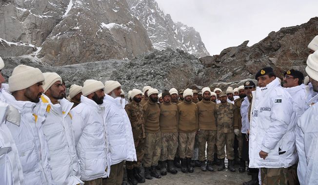 Gen. Ashfaq Parvez Kayani (second from right), Pakistan&#x27;s army chief, talks to soldiers on Sunday, April 8, 2012, during a visit to the site of an avalanche that buried more than 120 soldiers in Siachen, Pakistan, on Saturday. (AP Photo/Pakistani Inter Services Public Relations)