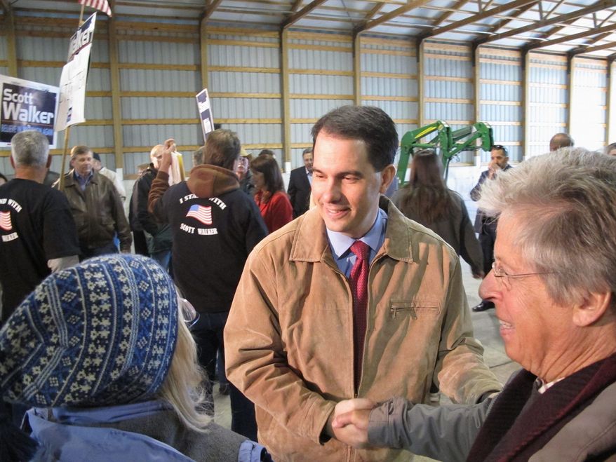 Wisconsin Gov. Scott Walker greets supporters in Dane, Wis., Tuesday in the first of six campaign stops across the state intended to let him greet voters personally as he and Lt. Gov. Rebecca Kleefisch fight recall efforts. The primary is May 5 and the general election is June 5. (Associated Press)