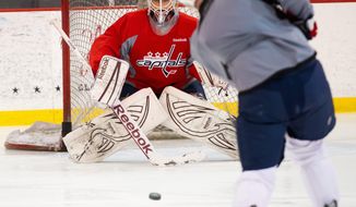 Braden Holtby, focusing on a shot by Jason Chimera during practice, has played in just seven NHL games this season. Drawing inspiraton from his mask, he will attempt to become the first rookie goalie to lead his team to a Stanley Cup title since Carolina&#39;s Cam Ward in 2006. (Andrew Harnik/The Washington Times)