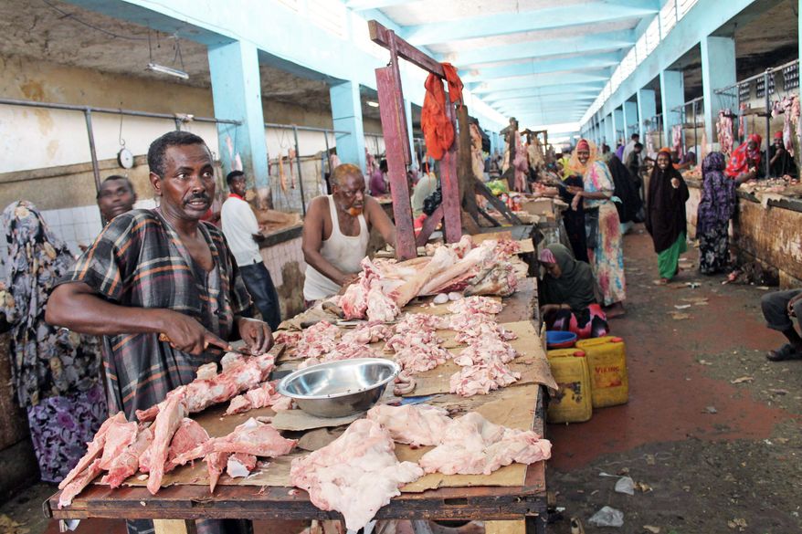 Somalis sell meat in the bustling Hamarweyne market in Mogadishu. While poverty is still prevalent, the city is rebounding quickly from the brutal rule of al-Shabab. "I had never dreamed that I would either walk through Mogadishu's streets or drive my car at night," resident Abdiaziz Nur said. (Associated Press)