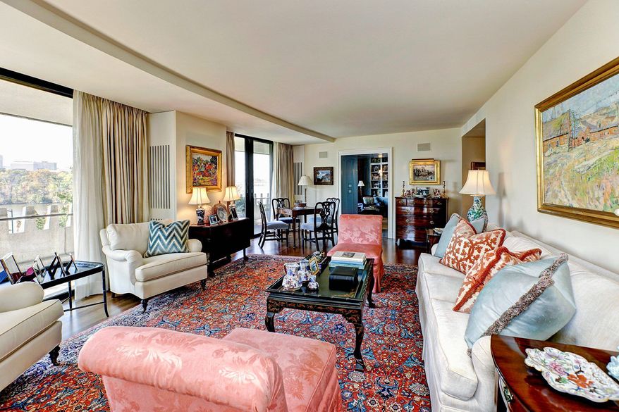The living room is nearly surrounded by floor-to-ceiling glass doors.