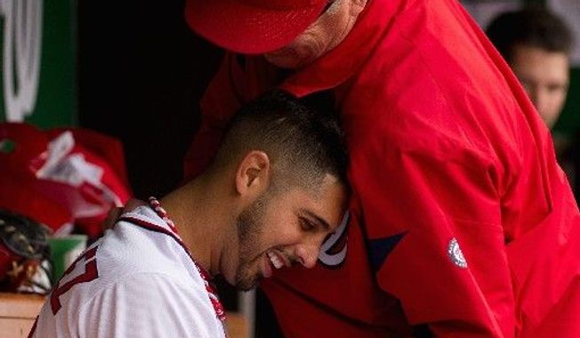 Nationals starter Gio Gonzalez gets a playful punch  from a coach after working seven shutout innings against Cincinnati. Gonzalez added to the Nationals' pitching dominance of late, as the starters haven't allowed a run in the last three games. (Andrew Harnik/The Washington TImes)