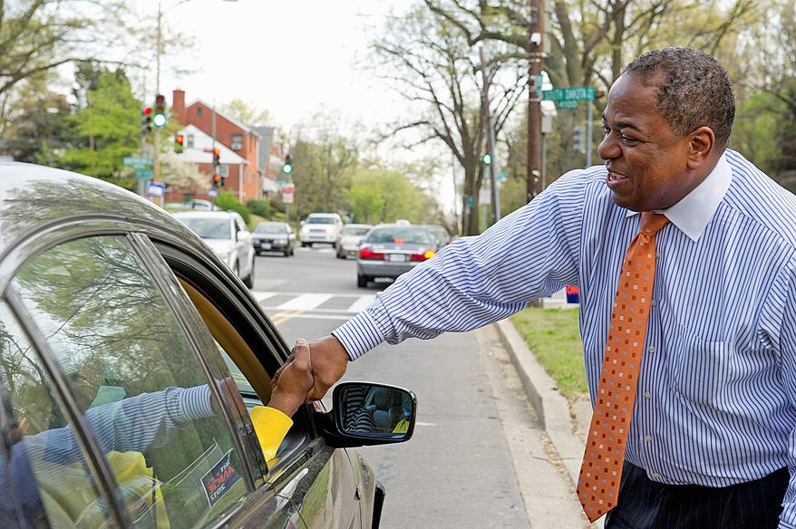 D.C. Council member Vincent B. Orange shakes hands with a supporter outside his campaign headquarters on South Dakota Avenue in Northeast D.C., on Friday, March 30, 2012. (Barbara L. Salisbury/The Washington Times)