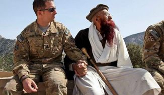 Army Capt. Mark Moretti meets with a village elder before his unit leaves an outpost in the Korengal Valley of Afghanistan. During a shift in tactics, U.S. forces gave up a network of hilltop platoon outposts in favor of a more mobile engagement of the Taliban. (Department of Defense)