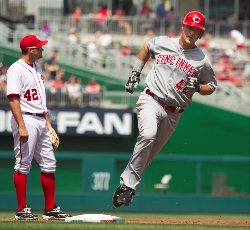 Cincinnati's Ryan Ludwick rounds the bases after hitting a grand slam off Ross Detwiler during the first inning. Tyler Clippard had his problems in the 11th, allowing three runs in the Nationals' 8-5 loss. (Associated Press)