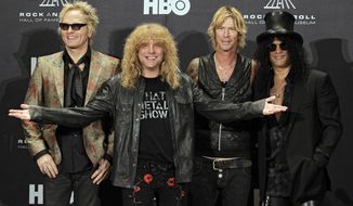 Four members of the band Guns N&#39; Roses — (from left) Matt Sorum, Steven Adler, Duff McKagan and Slash — appear in the press room early on Sunday, April 15, 2012, after their induction into the Rock and Roll Hall of Fame in Cleveland. (AP Photo/Amy Sancetta)