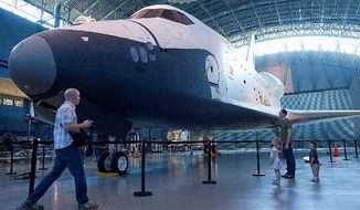 Getting a last look at Space Shuttle Enterprise are (from left) Jonathan Featherstone of Oakton, his children Emmie, 4, and Luke, 2, and his brother, Michael, at the Smithsonian&#39;s Stephen F. Udvar-Hazy Center in Chantilly. (Barbara L. Salisbury/The Washington Times)