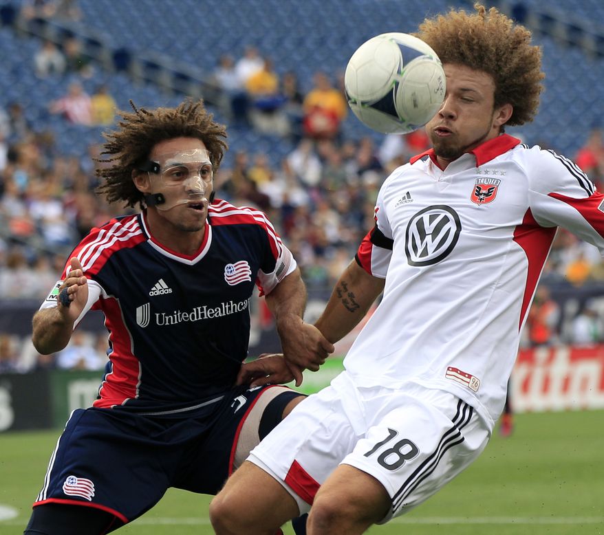 D.C. United's Nick DeLeon (18) controls the ball against New England Revolution's Kevin Alston during the first half of an MLS soccer match in Foxborough, Mass., on Saturday, April 14, 2012. (AP Photo/Elise Amendola)