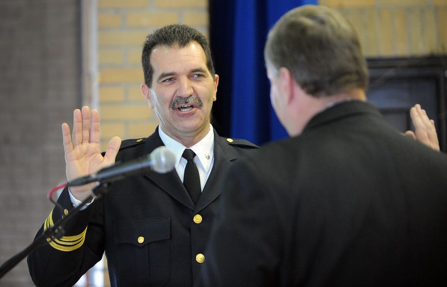 ** FILE ** Indianapolis Mayor Greg Ballard (right) swears in Paul Ciesielski (left) as the city's new police chief during a ceremony at the Brookside Community Center in Indianapolis on Feb. 25, 2010. (AP Photo/The Indianapolis Star, Matt Kryger )