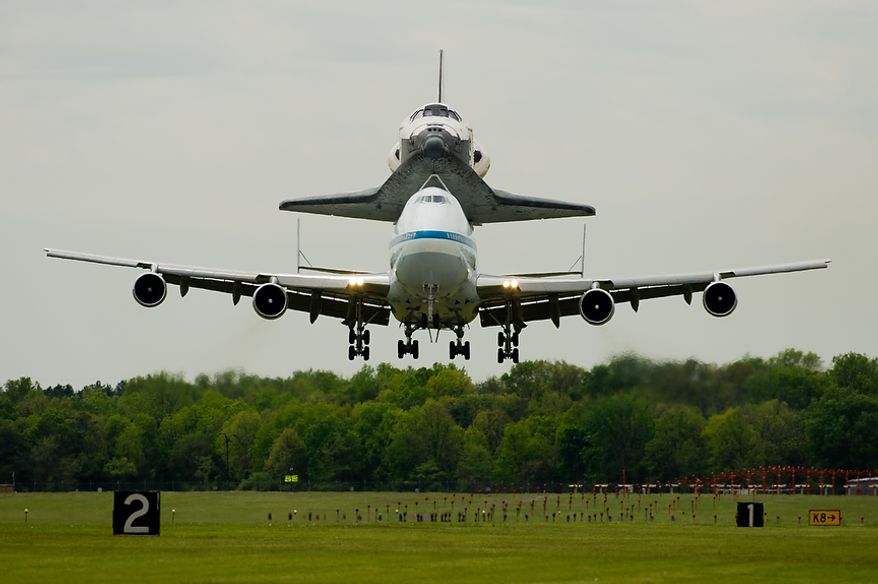 The space shuttle Discovery arrives by 747 carrier aircraft at Washington Dulles International Airport, Chantilly, Va., Tuesday, April 17, 2012. After completing 39 missions and spending 365 days in space, the historic spacecraft will make its final destination at the Steven F. Udvar-Hazy Center, a Smithsonian museum, located in Chantilly, Va. on Thursday, April 19th. (Andrew Harnik/The Washington Times)