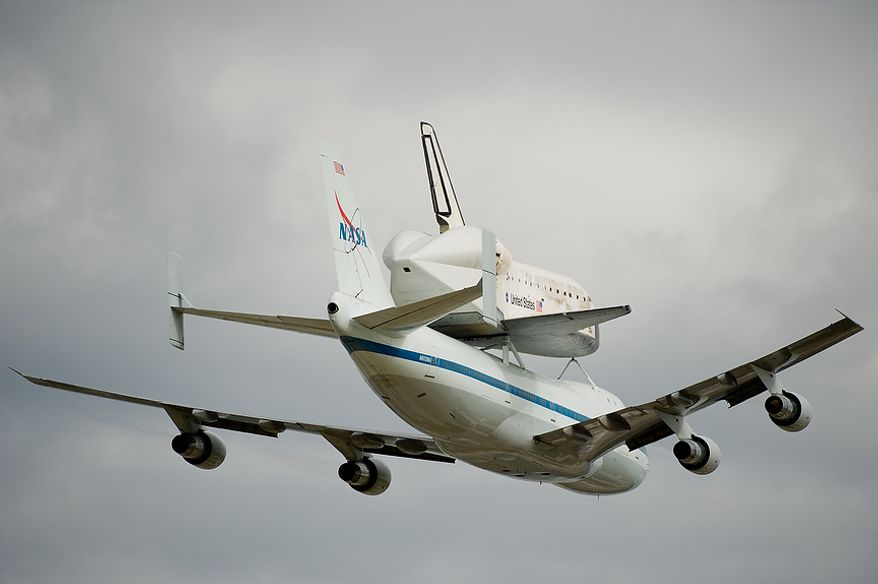 The Space shuttle Discovery does a flyby before arriving by 747 carrier aircraft at Washington Dulles International Airport, Chantilly, Va., Tuesday, April 17, 2012. After completing 39 missions and spending 365 days in space, the historic spacecraft will make its final destination at the Steven F. Udvar-Hazy Center, a Smithsonian museum, located in Chantilly, Va. on Thursday, April 19th. (Andrew Harnik/The Washington Times)