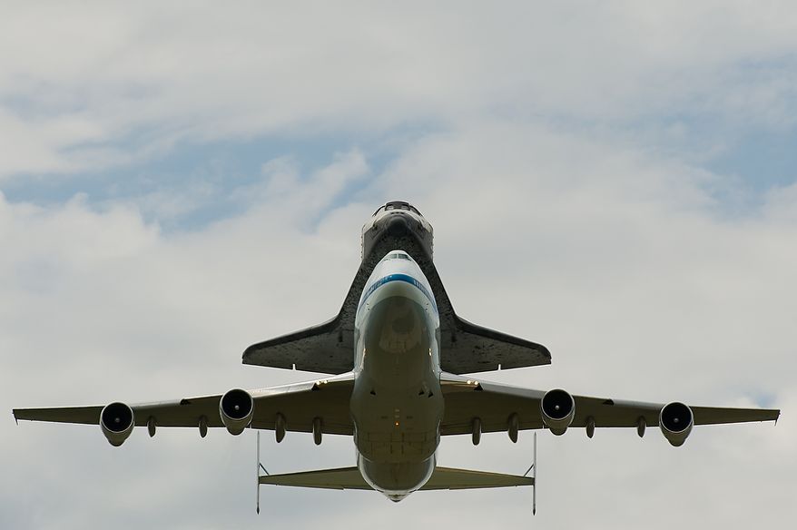 The space shuttle Discovery does a flyby before arriving by 747 carrier aircraft at Washington Dulles International Airport, Chantilly, Va., Tuesday, April 17, 2012. After completing 39 missions and spending 365 days in space, the historic spacecraft will make its final destination at the Steven F. Udvar-Hazy Center, a Smithsonian museum, located in Chantilly, Va. on Thursday, April 19th. (Andrew Harnik/The Washington Times)