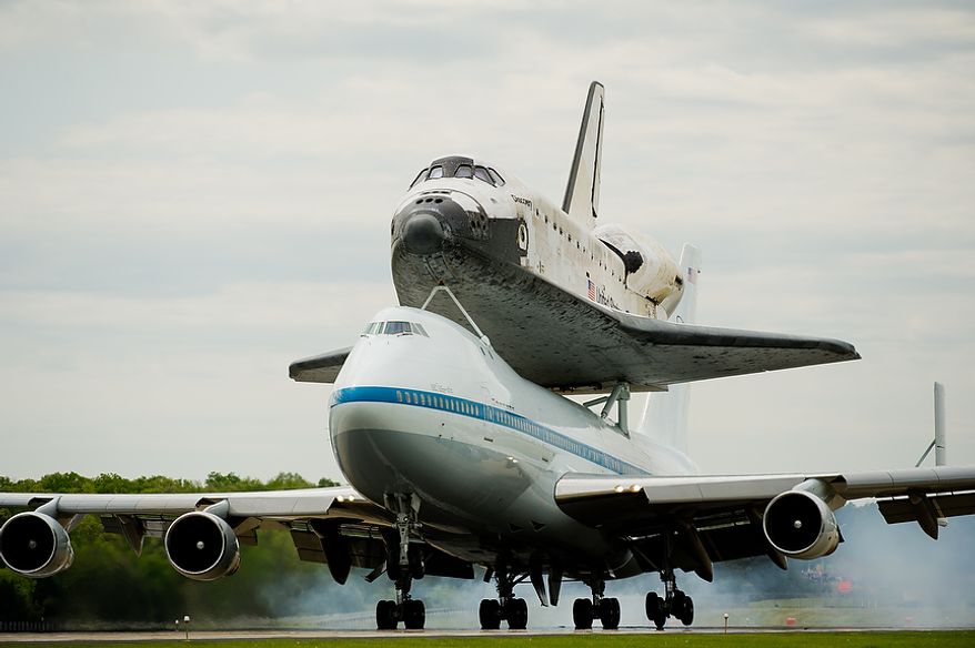 The space shuttle Discovery arrives by 747 carrier aircraft at Washington Dulles International Airport, Chantilly, Va., Tuesday, April 17, 2012. After completing 39 missions and spending 365 days in space, the historic spacecraft will make its final destination at the Steven F. Udvar-Hazy Center, a Smithsonian museum, located in Chantilly, Va. on Thursday, April 19th. (Andrew Harnik/The Washington Times)
