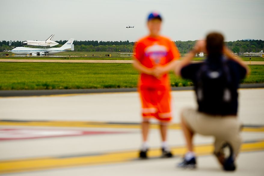The space shuttle Discovery arrives by 747 carrier aircraft at Washington Dulles International Airport, Chantilly, Va., Tuesday, April 17, 2012. After completing 39 missions and spending 365 days in space, the historic spacecraft will make its final destination at the Steven F. Udvar-Hazy Center, a Smithsonian museum, located in Chantilly, Va. on Thursday, April 19th. (Andrew Harnik/The Washington Times)