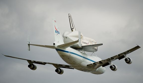 The Space shuttle Discovery does a flyby before arriving by 747 carrier aircraft at Washington Dulles International Airport, Chantilly, Va., Tuesday, April 17, 2012. After completing 39 missions and spending 365 days in space, the historic spacecraft will make its final destination at the Steven F. Udvar-Hazy Center, a Smithsonian museum, located in Chantilly, Va. on Thursday, April 19th. (Andrew Harnik/The Washington Times)
