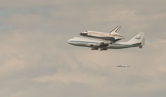 The NASA Space Shuttle Discovery is seen being carried piggyback on a modified Boeing 747, in the skies above Washington, D.C., Tuesday, April 17, 2012, as it makes it&#39;s way to the Steven F. Udvar-Hazy Center in Chantilly, Va. (Rod Lamkey Jr/The Washington Times)