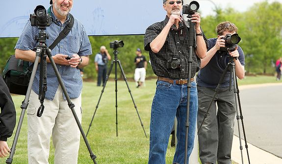 Jon Jelling of Leesburg, Va., Jim Sample of Manassas, Va. and Dane Smith of Fairfax, Va., set up their cameras to get a shot of the space shuttle Discovery as it flies past the Smithsonian Air and Space Museum&#39;s Udvar-Hazy Center in Chantilly, Va., on Tuesday, April 17, 2012. Thousands of people came out to the museum to see the shuttle fly by on its way to Washington Dulles International Airport. (Barbara L. Salisbury/The Washington Times)