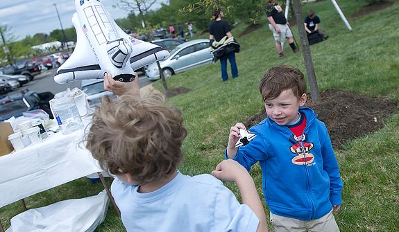 Drew Schwartzman, left, 5, of Baltimore, Md., and Alexander Leigh, 3, of Round Hill, Va., play with toy shuttles outside the Smithsonian Air and Space Museum&#39;s Udvar-Hazy Center in Chantilly, Va., on Tuesday, April 17, 2012 as they wait for the space shuttle Discovery to fly by on its way to Washington Dulles International Airport. (Barbara L. Salisbury/The Washington Times)