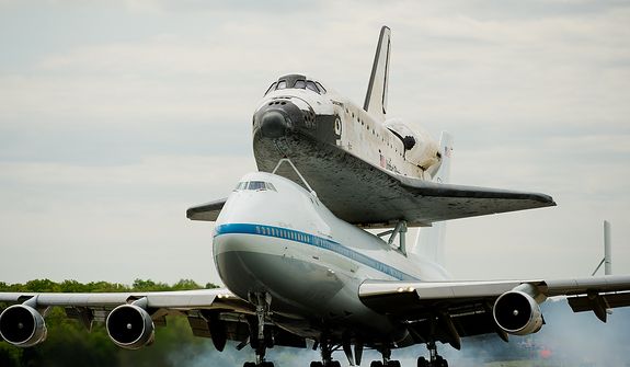The space shuttle Discovery arrives by 747 carrier aircraft at Washington Dulles International Airport, Chantilly, Va., Tuesday, April 17, 2012. After completing 39 missions and spending 365 days in space, the historic spacecraft will make its final destination at the Steven F. Udvar-Hazy Center, a Smithsonian museum, located in Chantilly, Va. on Thursday, April 19th. (Andrew Harnik/The Washington Times)